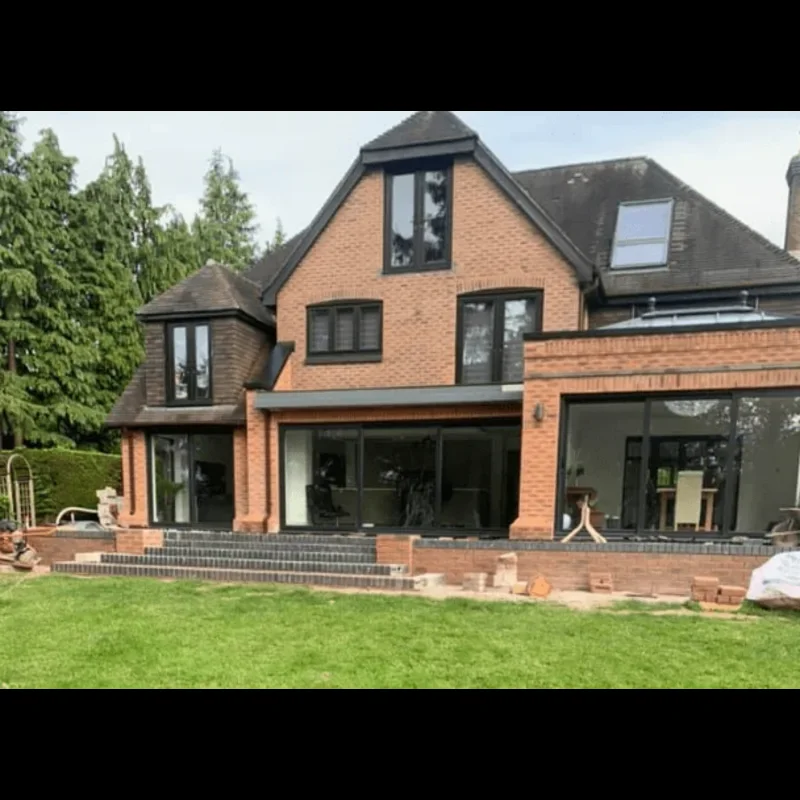 Completed rear house extension in Cardiff with black bi-fold doors and brick steps, built by Ever Best Building